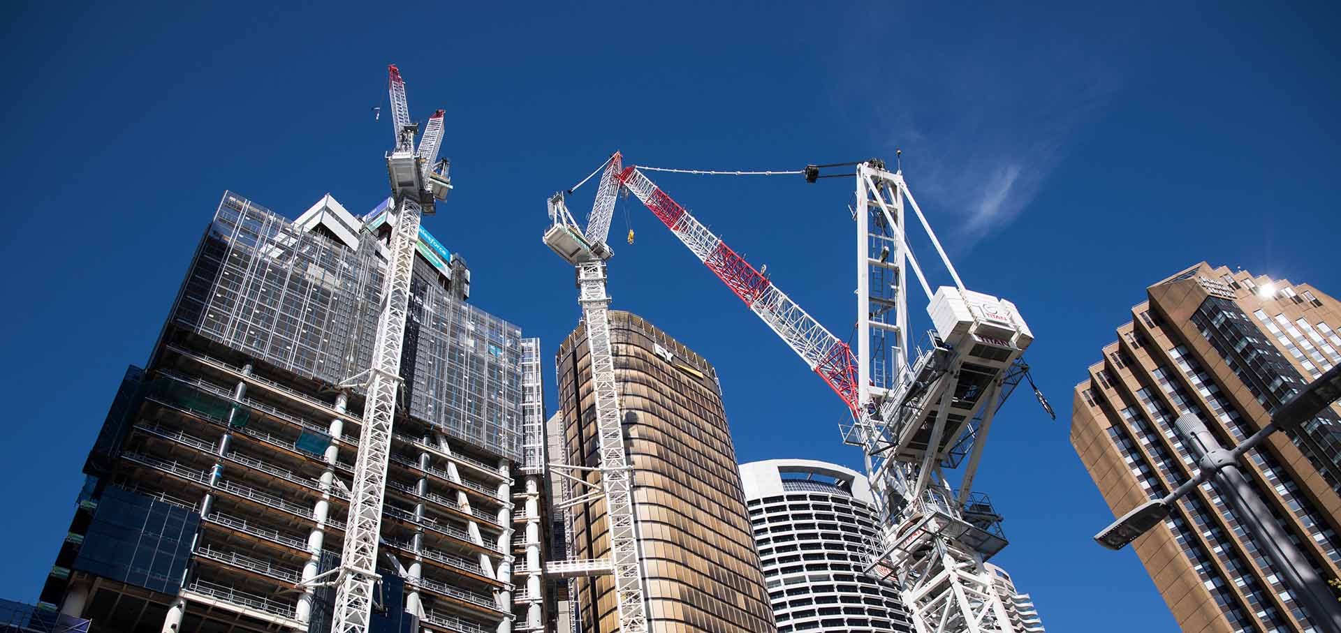 Partially completed building with cranes in operation.